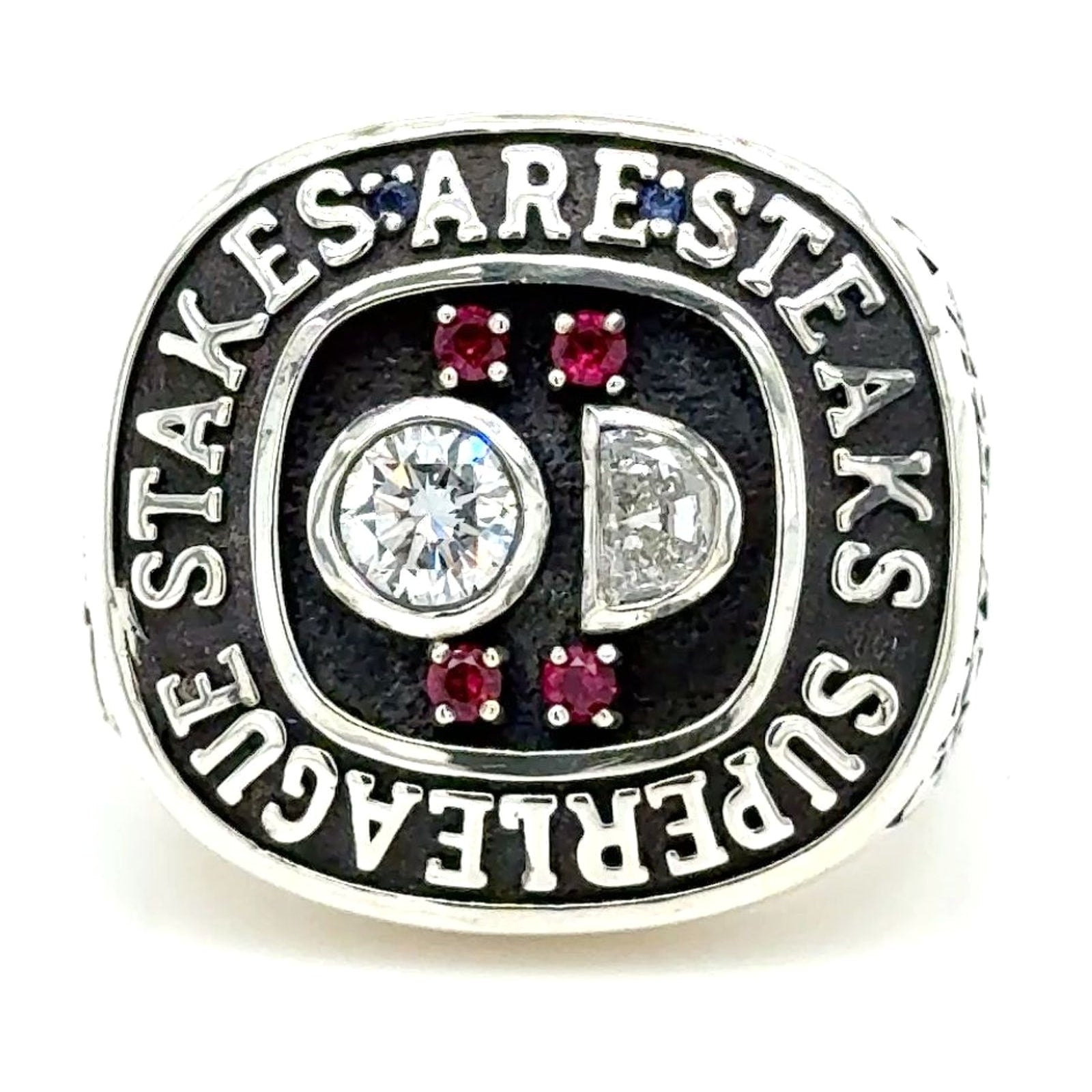 Custom estate-style ring with diamonds and red gemstones